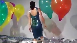 Sexy Girl In Latex Dress Blows to Pop Some Big Balloons